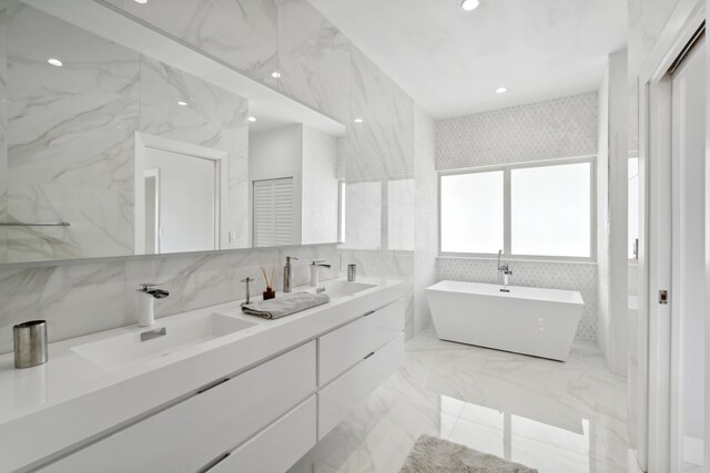 bathroom with vanity and a bath