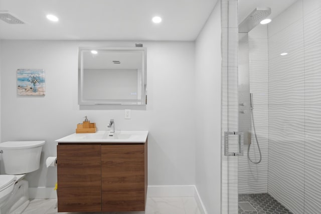 bathroom featuring vanity, an enclosed shower, and toilet