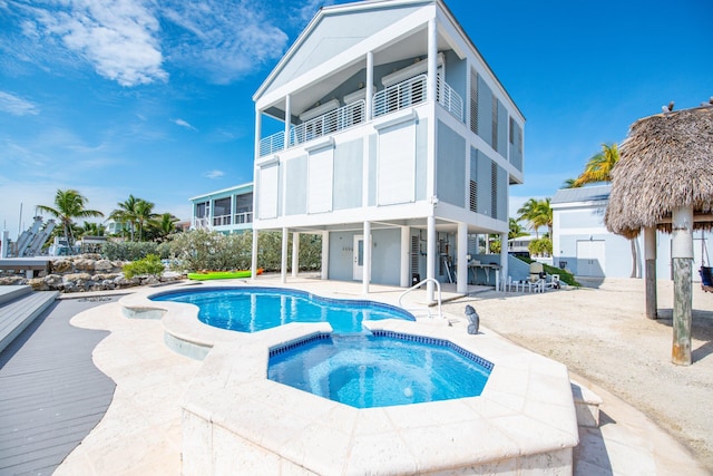 view of pool featuring an in ground hot tub and a patio area