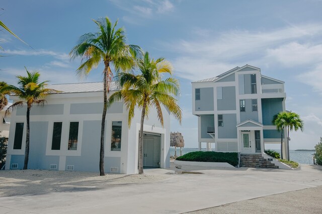 view of front facade with a water view and a garage