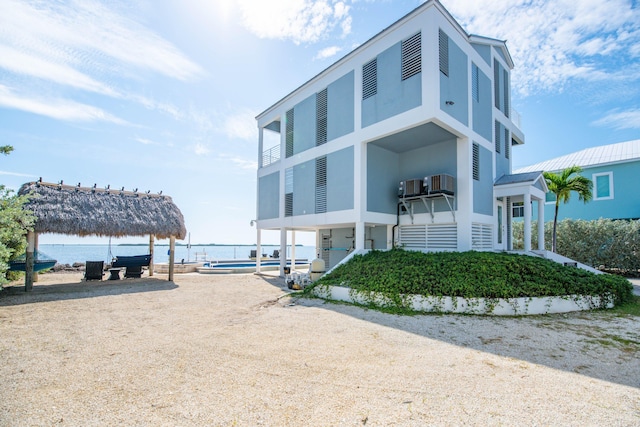 exterior space with a gazebo, a water view, and cooling unit