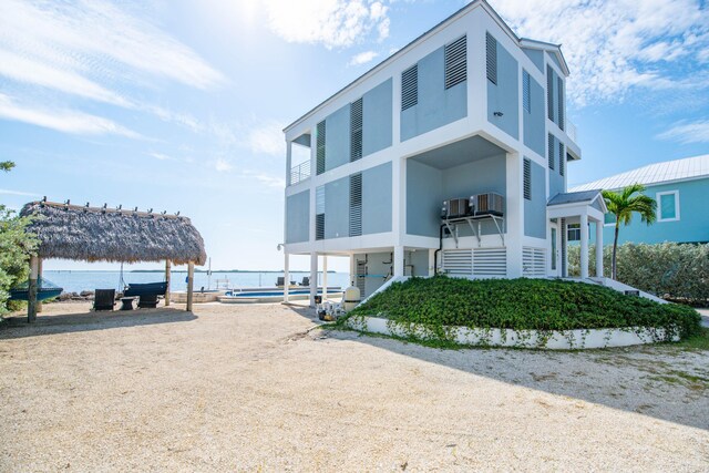 exterior space with a gazebo, a water view, and cooling unit