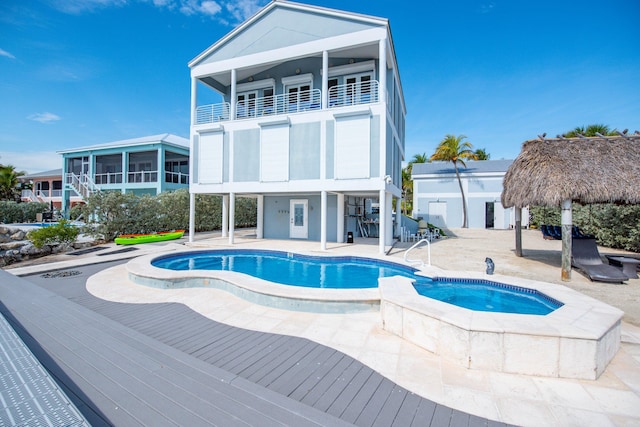 view of pool featuring an in ground hot tub, a gazebo, and a patio