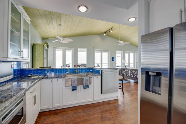 kitchen with appliances with stainless steel finishes, pendant lighting, white cabinets, and ceiling fan