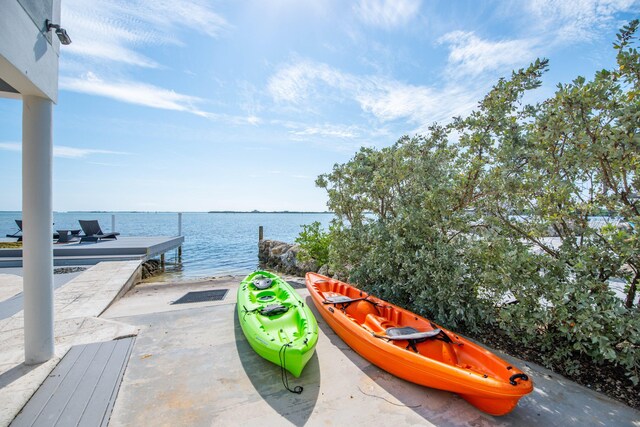 view of patio with a dock and a water view