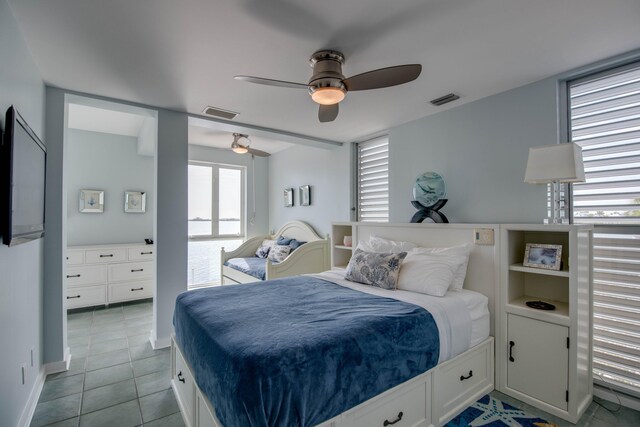 tiled bedroom featuring ceiling fan