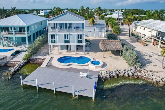 back of house with a water view, a patio, and a balcony