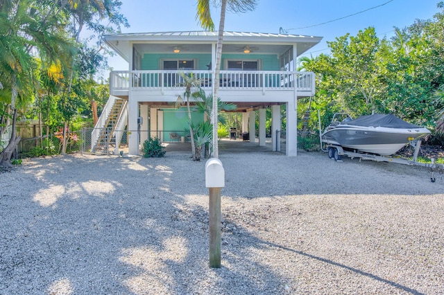 view of front of home featuring a carport, ceiling fan, and covered porch