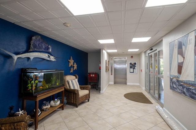 interior space with light tile patterned floors and elevator