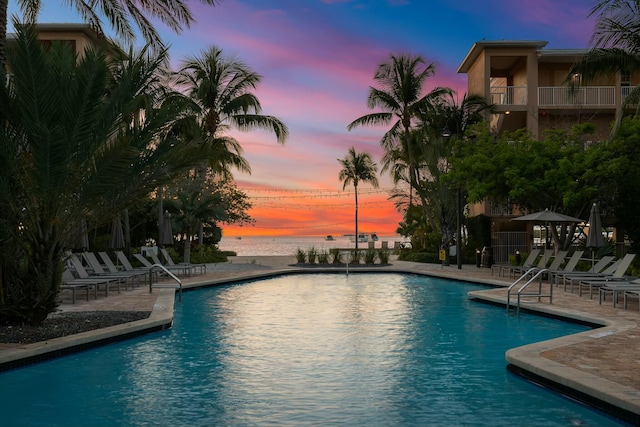 3841 N Roosevelt Blvd Unit 315, Key West, FL 33040 - pool at dusk featuring a water view, a patio, and a community pool
