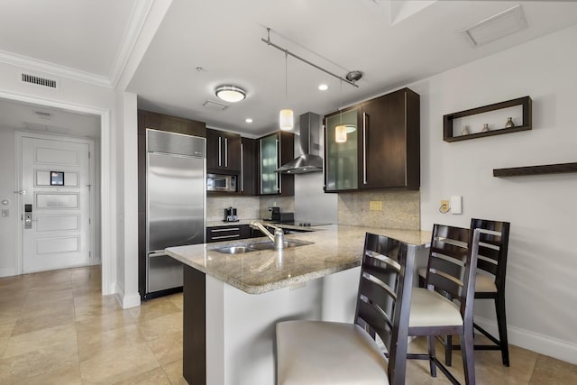 3841 N Roosevelt Blvd Unit 315, Key West, FL 33040 - kitchen with wall chimney range hood, a peninsula, visible vents, appliances with stainless steel finishes, and a sink