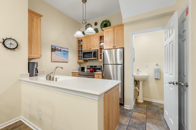 kitchen featuring appliances with stainless steel finishes, decorative light fixtures, kitchen peninsula, and sink