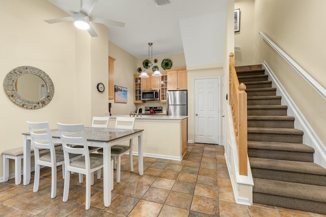 dining space featuring ceiling fan and sink