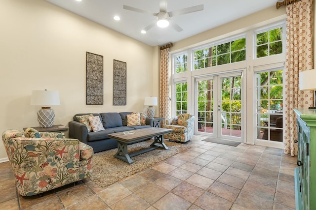 living room featuring french doors, ceiling fan, and a high ceiling