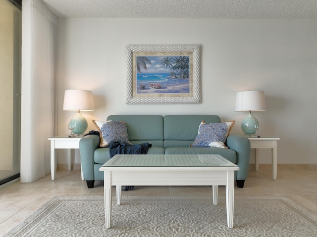 living room featuring a textured ceiling and light tile patterned floors