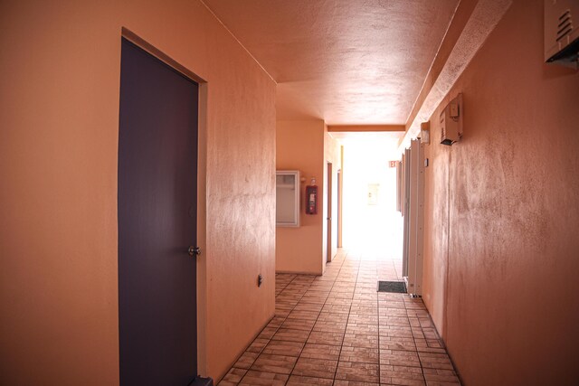 hallway with a textured ceiling