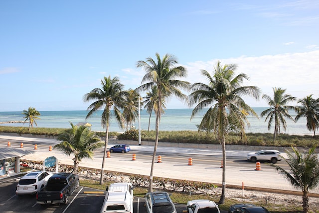 view of car parking with a water view