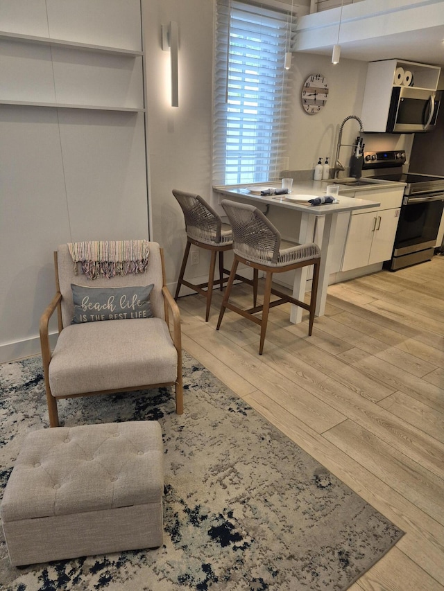 1220 Newton St Unit 1, Key West, FL 33040 - kitchen featuring appliances with stainless steel finishes, light wood-style floors, and white cabinets