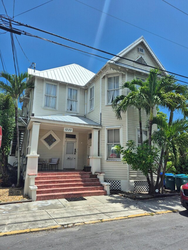 1220 Newton St Unit 1, Key West, FL 33040 - view of front of property featuring a metal roof, a porch, and a standing seam roof