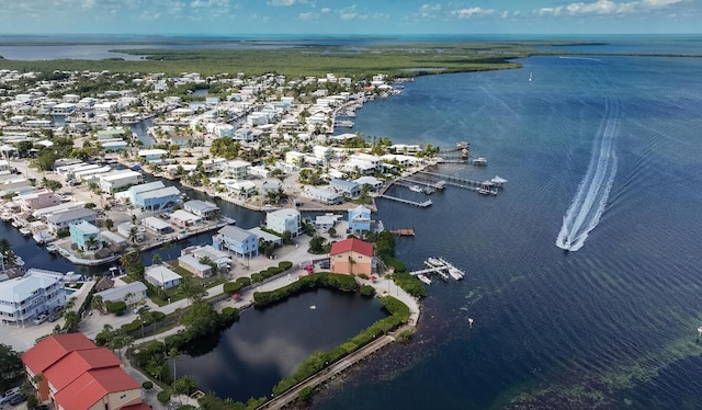 drone / aerial view featuring a residential view and a water view