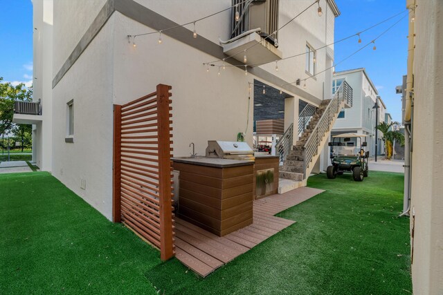 view of property exterior with a balcony and a yard