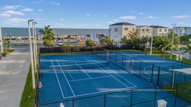 view of sport court with a water view