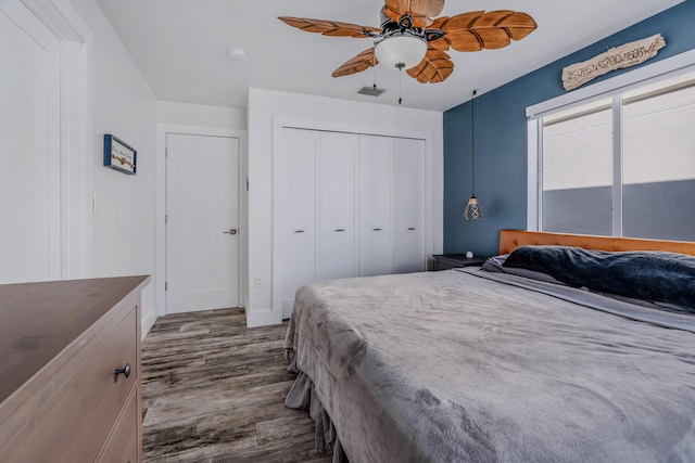 bedroom featuring wood-type flooring, a closet, and ceiling fan