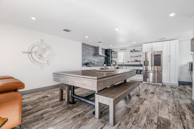 dining area featuring sink and light hardwood / wood-style flooring