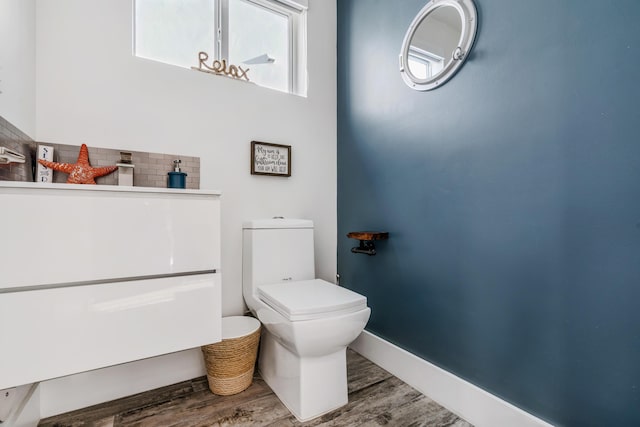 bathroom with wood-type flooring and toilet