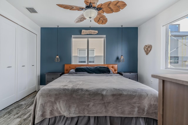 bedroom featuring wood-type flooring, a closet, and ceiling fan