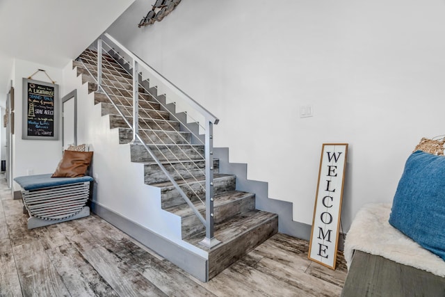 stairway with hardwood / wood-style flooring