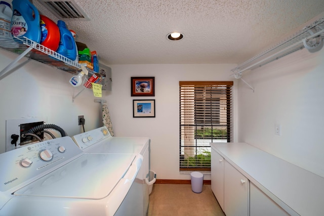 clothes washing area featuring light carpet, cabinet space, visible vents, a textured ceiling, and washing machine and dryer