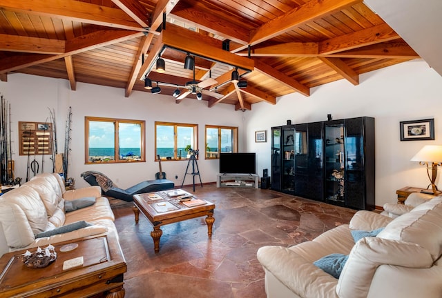 living room with lofted ceiling with beams, stone finish floor, wooden ceiling, and track lighting