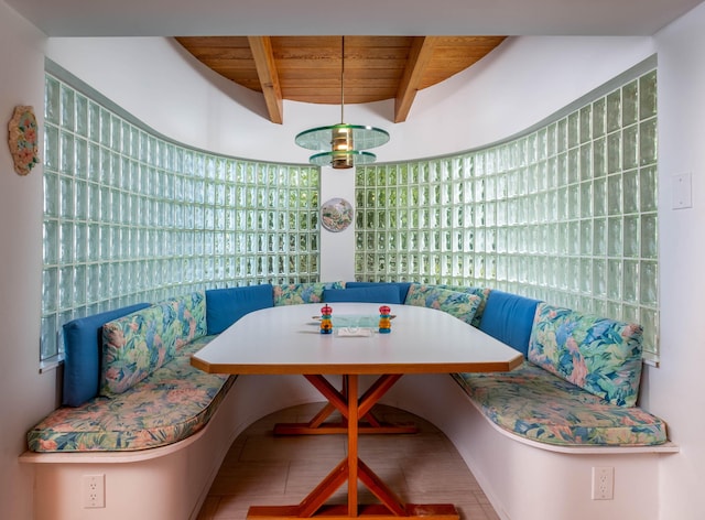dining area featuring wooden ceiling, plenty of natural light, breakfast area, and beamed ceiling