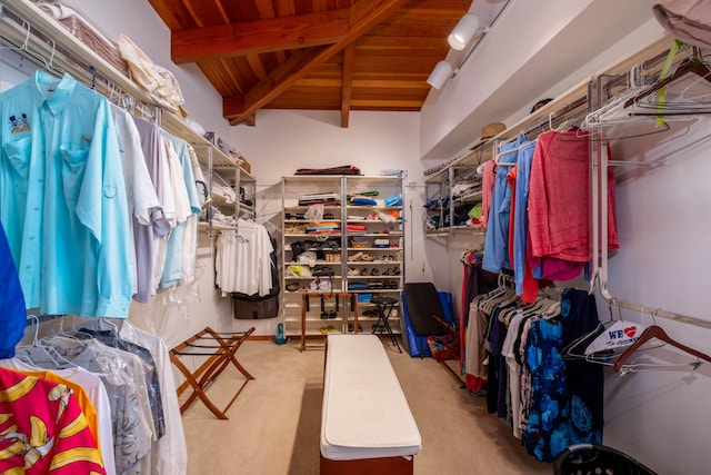 spacious closet featuring lofted ceiling with beams and carpet
