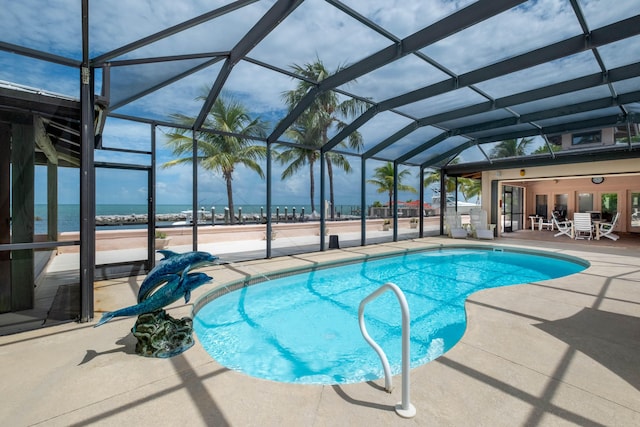 outdoor pool with a patio, a water view, and a lanai