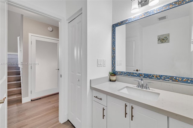 bathroom with vanity and hardwood / wood-style floors