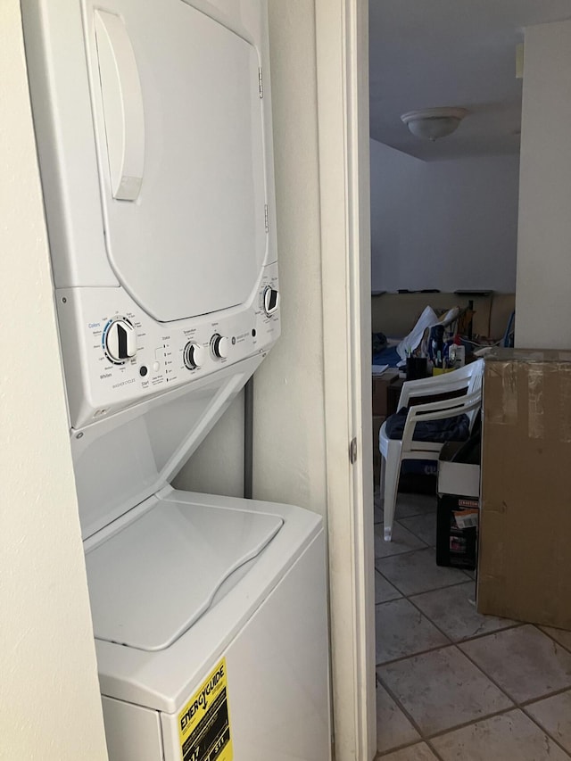 3930 S Roosevelt Blvd Unit N303, Key West, FL 33040 - washroom with estacked washer and dryer and light tile patterned floors
