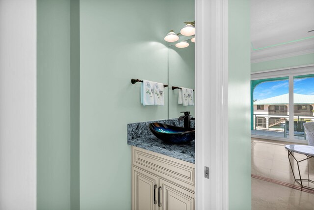 bathroom featuring crown molding and vanity