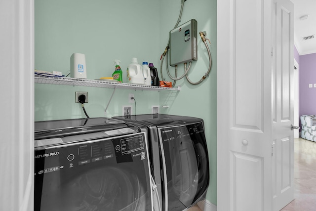 laundry area featuring washing machine and clothes dryer