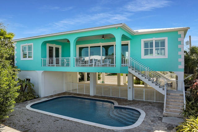 rear view of house with ceiling fan