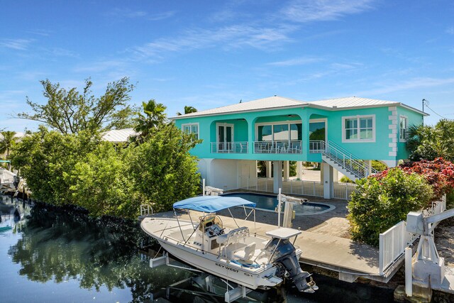 rear view of house featuring a water view