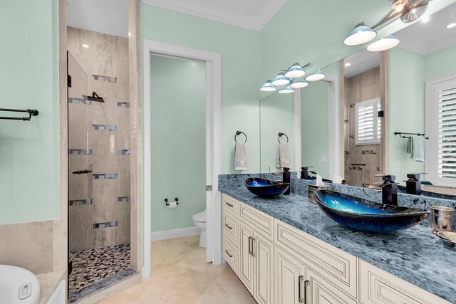 bathroom featuring tile patterned flooring, vanity, tiled shower, and toilet