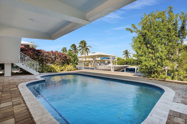 view of swimming pool with a patio area