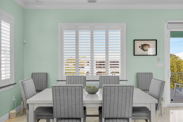 dining space with crown molding and a healthy amount of sunlight