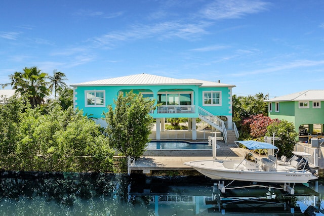 back of property featuring a water view