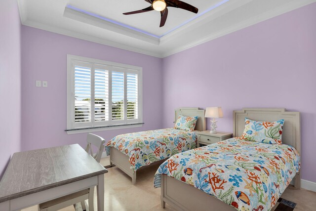 bedroom with crown molding, a tray ceiling, and light colored carpet