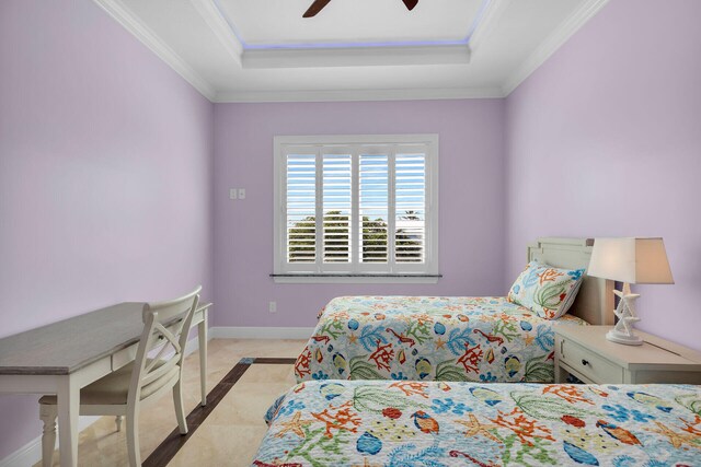 bedroom with crown molding, ceiling fan, and a tray ceiling