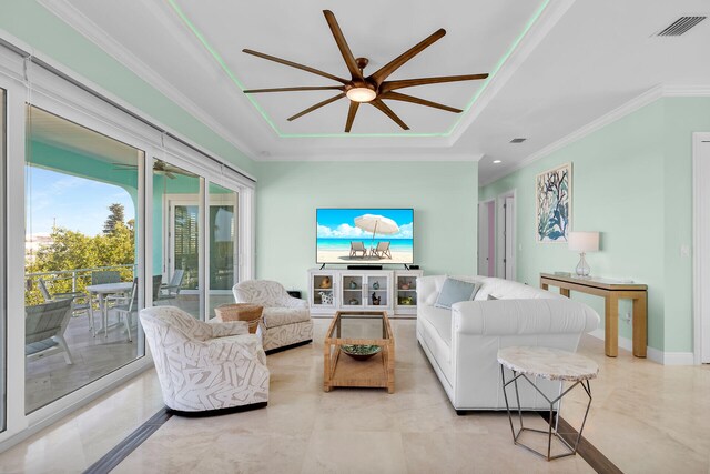 living room with a tray ceiling and crown molding