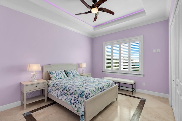 bedroom featuring ceiling fan, ornamental molding, and a raised ceiling